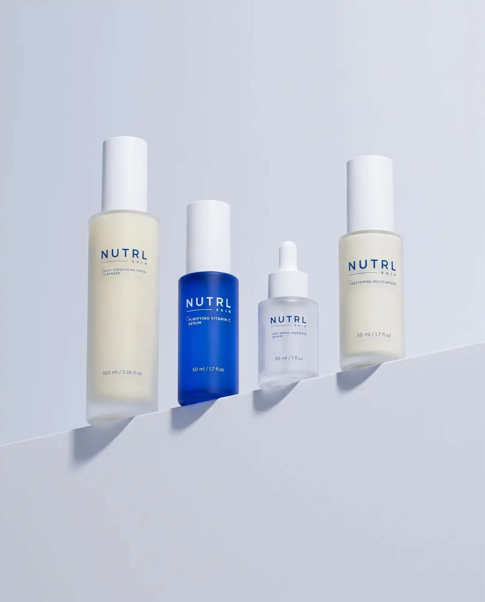 NUTRL Total Package - the four bottles lined up on a pale blue shelf