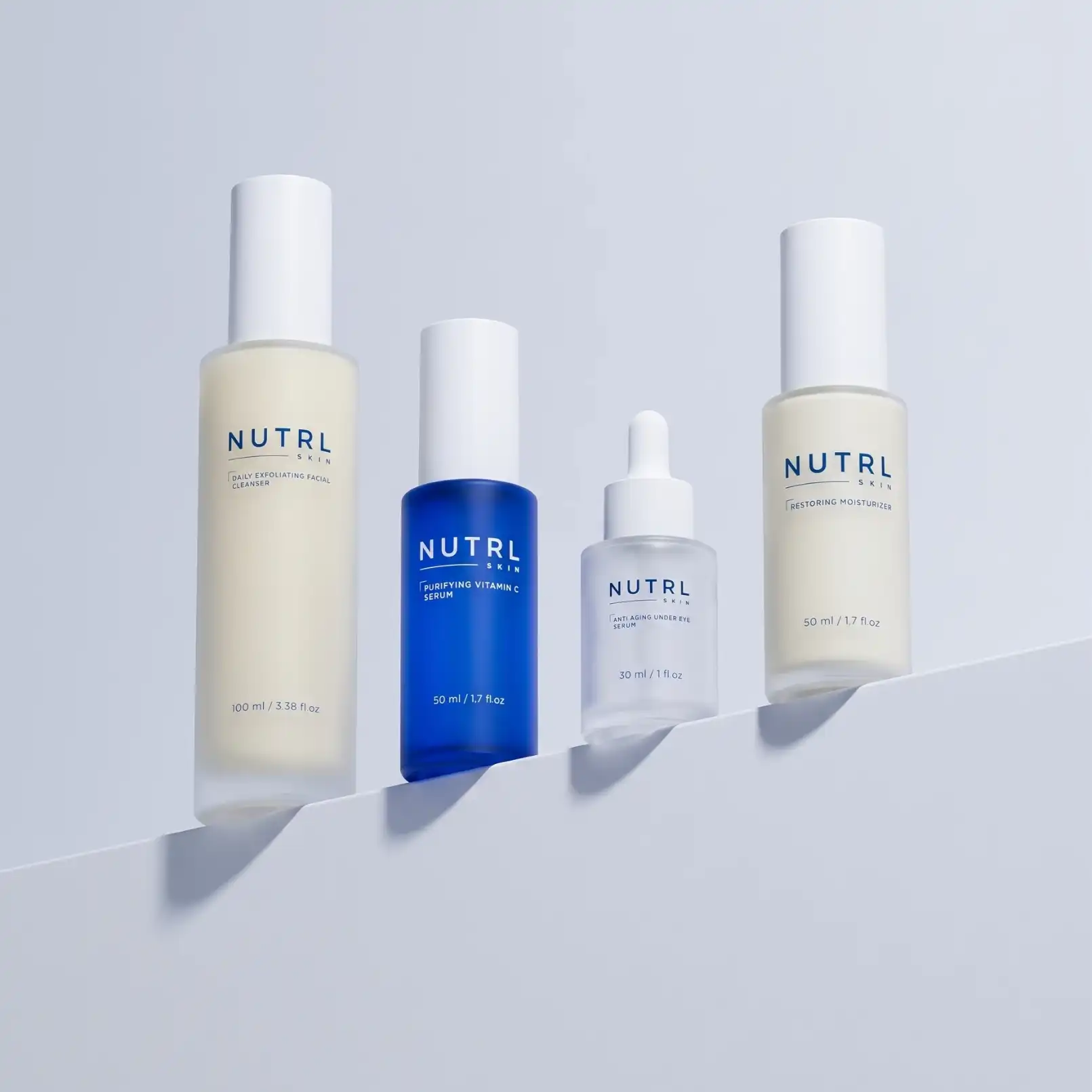 NUTRL Total Package - the four bottles lined up on a pale blue shelf