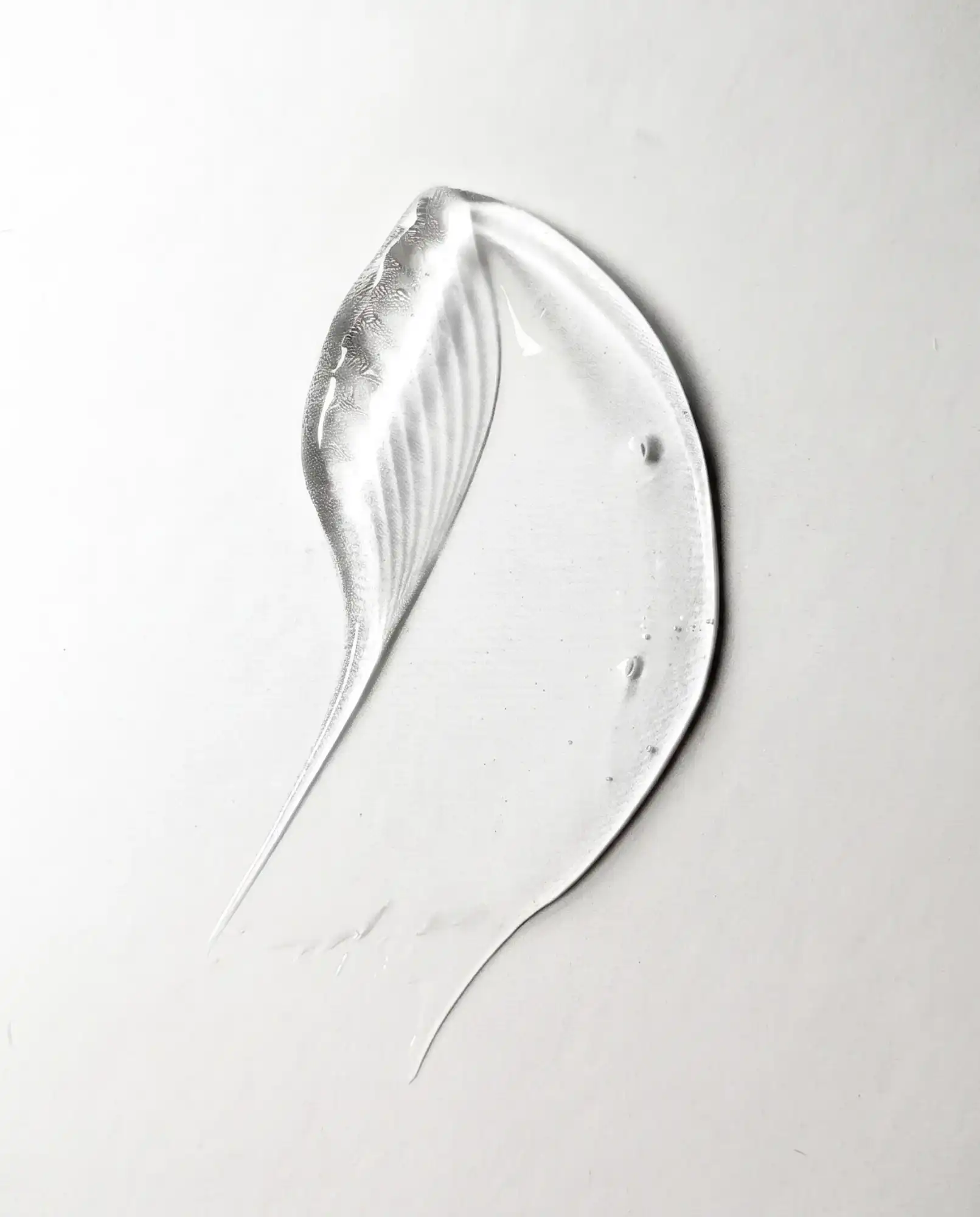 Clear serum texture swatch on a white surface