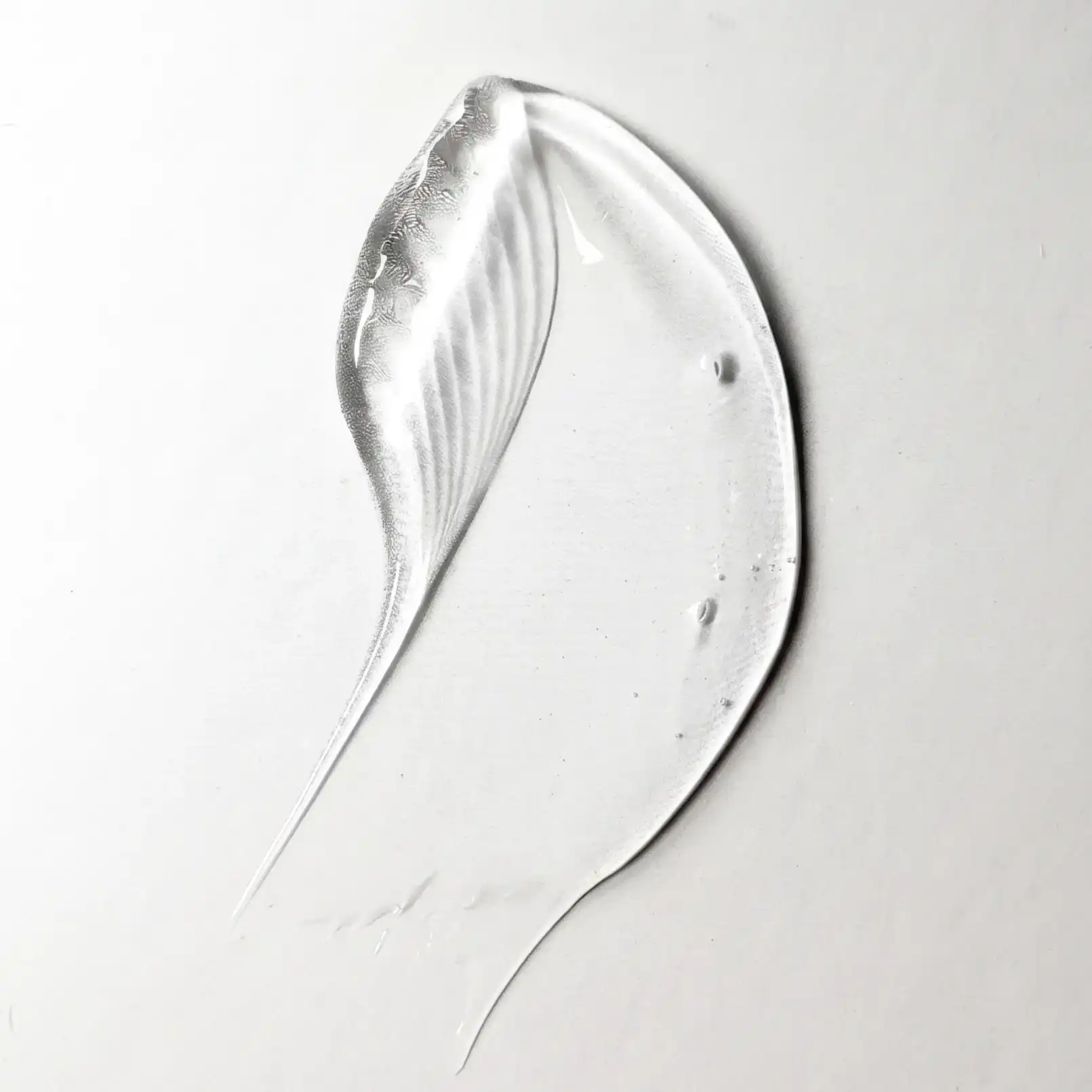 Clear serum texture swatch on a white surface