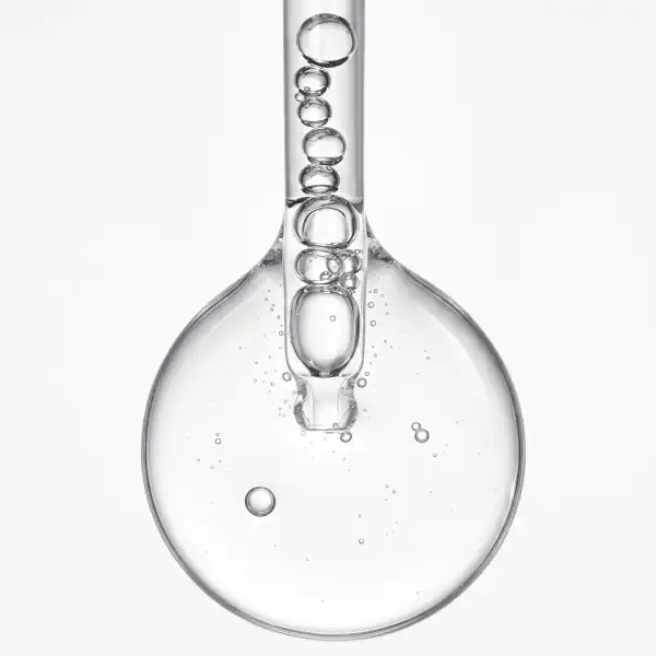 Pipette releasing a drop of clear serum